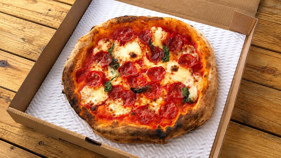 Wood-fired pepperoni pizza in an open box